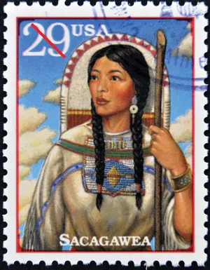 a postage stamp with a woman holding a staff